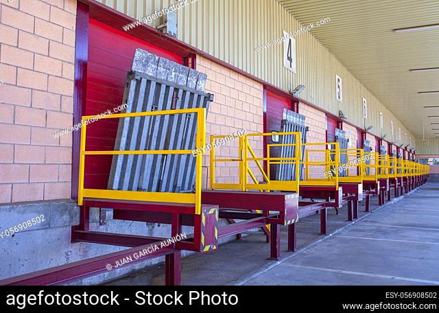 Truck loading docks at commercial building. Overhead door, dock leveler, and dock seals