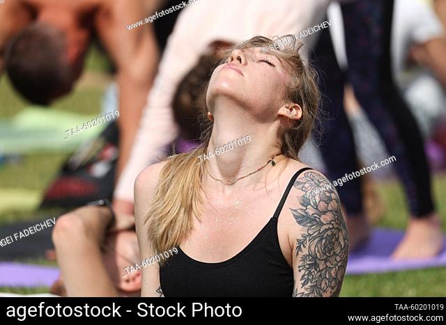 RUSSIA, MOSCOW - JULY 2, 2023: A woman does exercises during Yoga Day Russia 2023, a yoga festival marking the International Day of Yoga, in Tsaritsyno Park