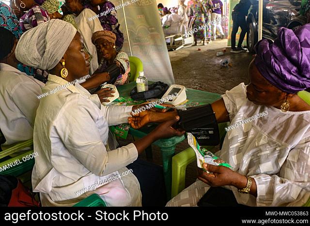 Medical personnel attend to woman during a free medical screening in commemoration of the International Day for Women at the Mobolaji Johnson Arena in Lagos