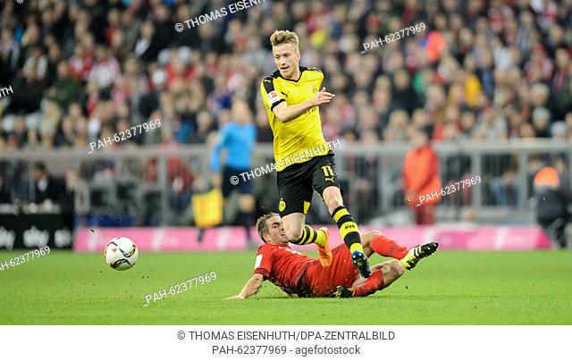 Munich's Philipp Lahm (bottom) and Dortmund's Marco Reus vie for the ball during the German Bundesliga soccer match between FC Bayern Munich and Borussia...
