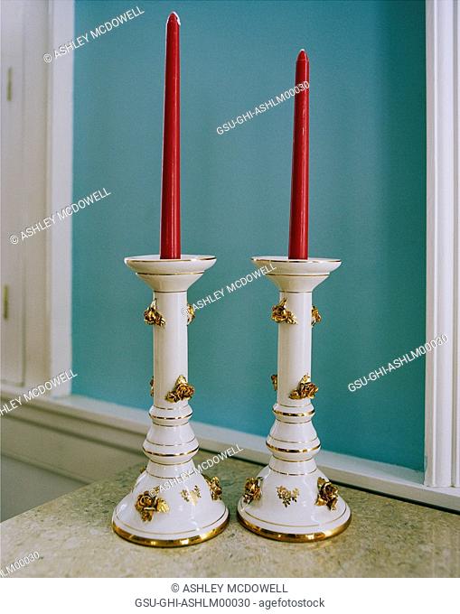Two Candlesticks with Red Tapered Candles