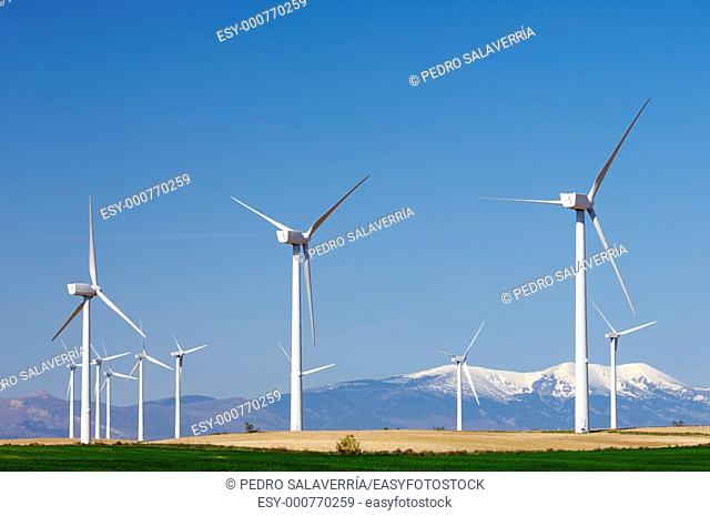 group of modern windmills background is the Moncayo peak in Pozuelo de Aragon, Saragossa, Spain