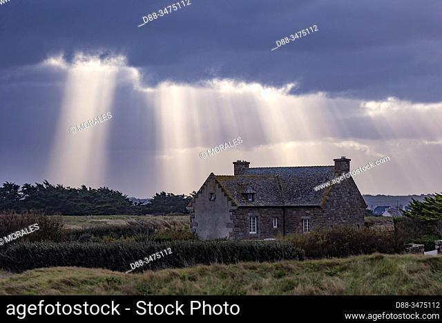 France, Finistere, Pagan Country, Coast of Legends, Meneham, house under the rays of the diffuse sun passing through clouds