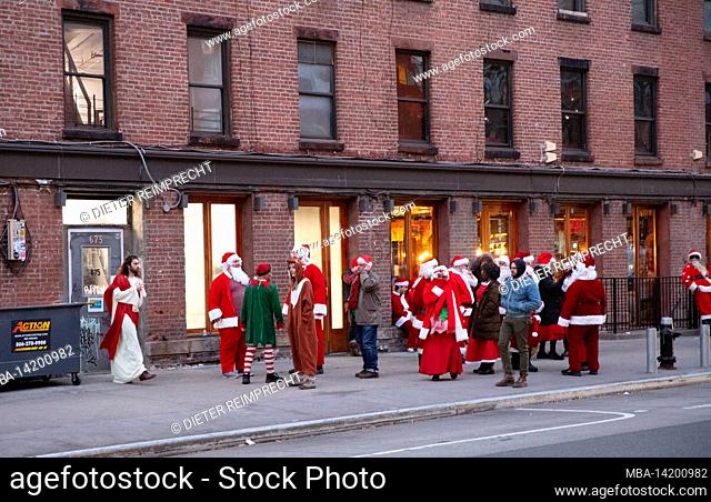 USA, New York City, Manhattan, Greenwich Village, Santa Clauses in front of a building