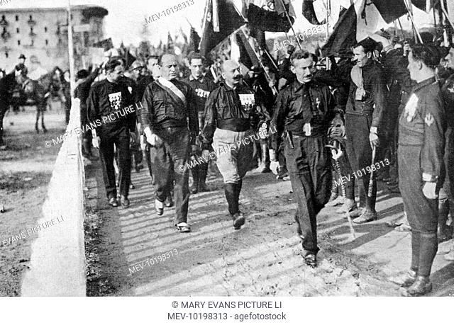 Prime minister Mussolini accompanied by his entourage reviews 40, 000 fascisti gathered on the campo sportivo at Naples