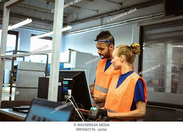 Two workers discussing with each other