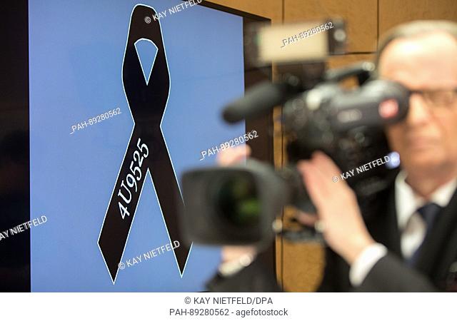 A journalist films the memorial bow on a display before the start of the press conference with Guenter Lubitz, father of the Germanwings co-pilot of the plane...