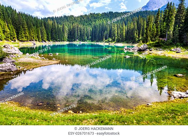 Perfectly clear emerald lake in the Dolomites at Latemar