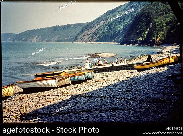 Clovelly Harbour, Clovelly, Torridge, Devon. A view looking south-east across the foreshore of Clovelly Harbour, with small boats beached on the shingle and...