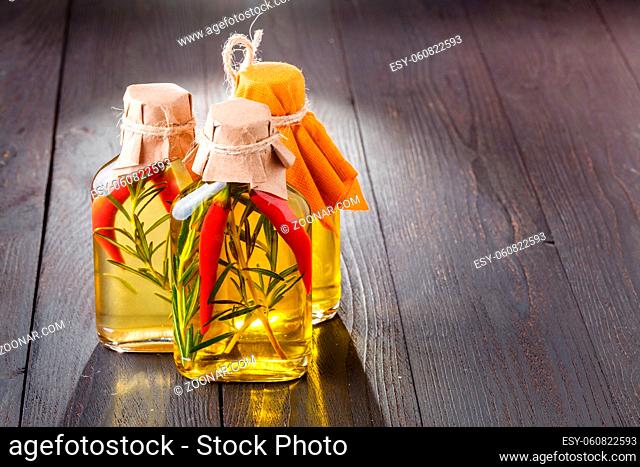 Bottles of extra virgin olive oil with aromatic herbs