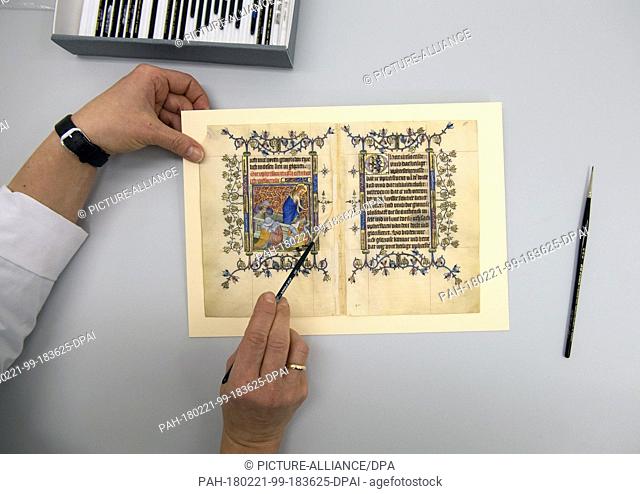 21 February 2018, Germany, Berlin: Restorer Katarzyna Schirmacher works on an original page of Mary of Guelders' prayer book