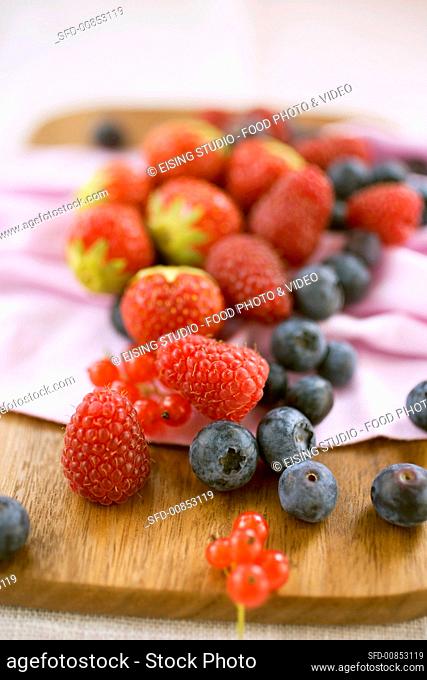 Mixed berries on chopping board