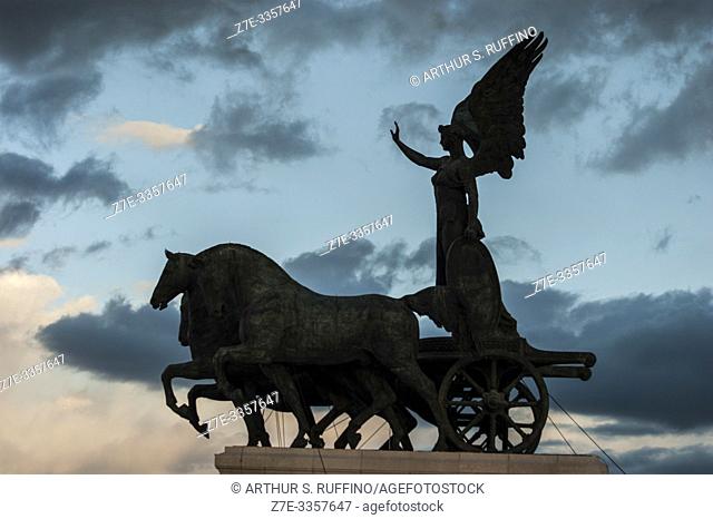 Silhouette of Statue of Goddess Victoria on a Quadriga (Winged Victory Statue) at sunset. Victor Emmanuel II Monument (Monumento Nazionale a Vittorio Emanuele...