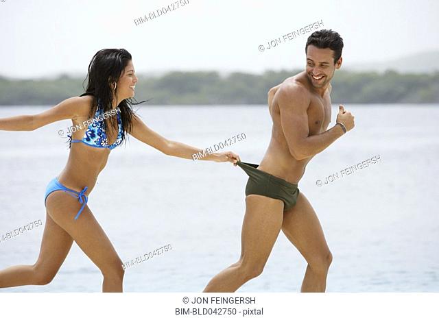 South American couple playing at beach