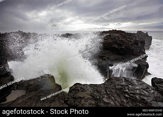 High tide waves splashing on rocks at Ponta da Ferraria, San Miguel, Azores, Portugal