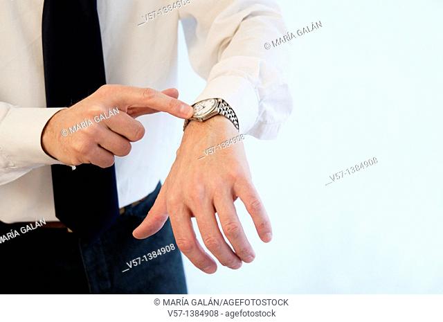 Man's hand pointing his watch. Close view