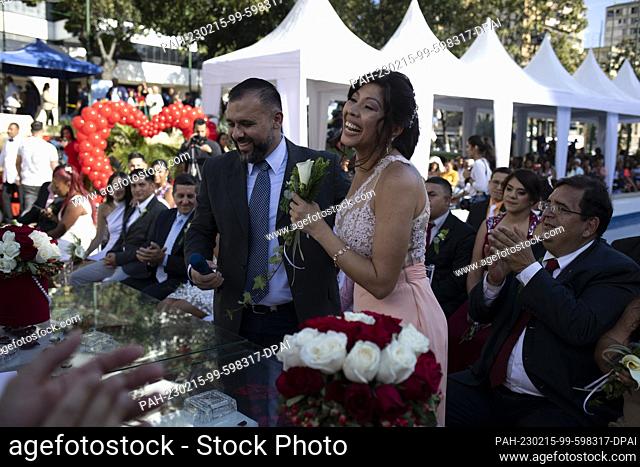 14 February 2023, Venezuela, Caracas: Couples and guests participate in a collective wedding ceremony organized by the Municipality of the Chacao neighborhood...