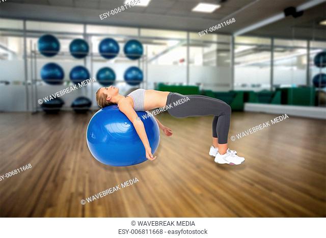 Composite image of fit young woman exercising with fitness ball