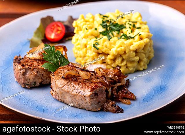 roasted pork fillet and spaetzle in a plate