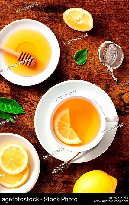 Lemon tea with honey, overhead flat lay shot. Healthy organic citrus detox beverage, natural remedy for cold and flu