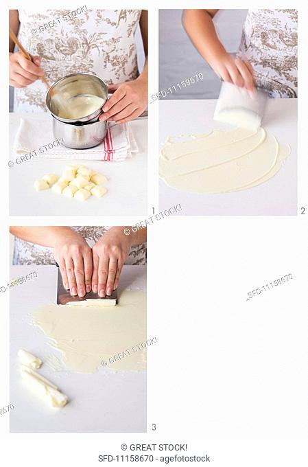 Curls of white chocolate being made