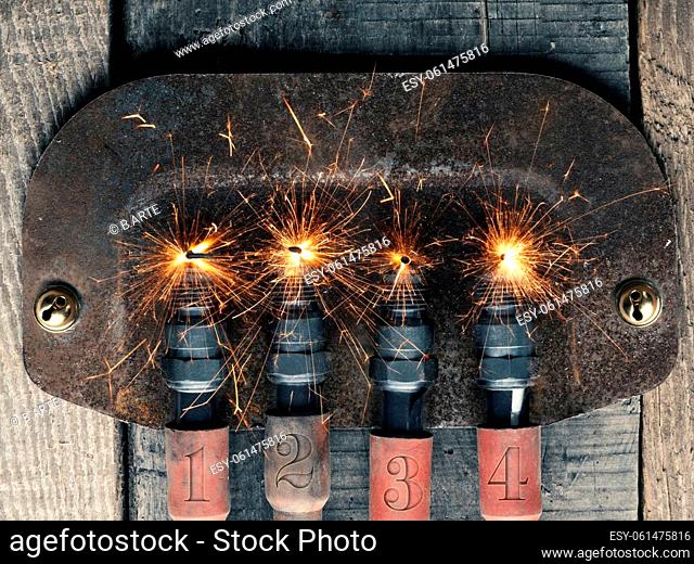 Fourth Advent background with four spark plugs on rusty sign, car workshop advent, concept image