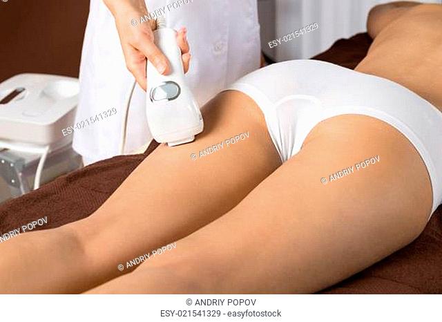 Close-up Of Woman Receiving Epilation Laser Treatment On Thigh