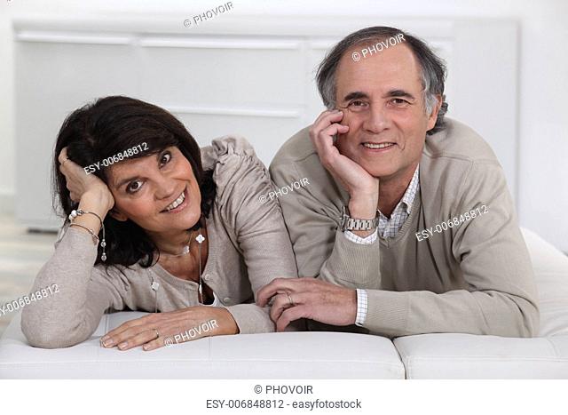 Middle-aged couple lying on a futon
