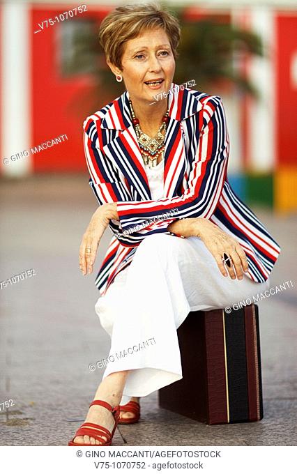 White, blue and red stripes dressed mature woman sitting