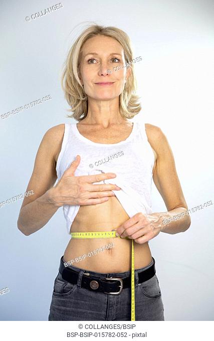 A woman measuring her waist