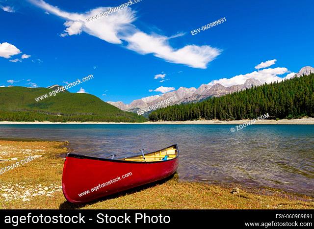 Red Canoe on the shore of a mountain lake, Peter Lougheed provincial Park, Alberta