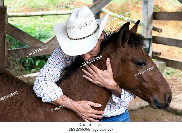 A Farmer Hugs His Colt; Zacapa, Guatemala