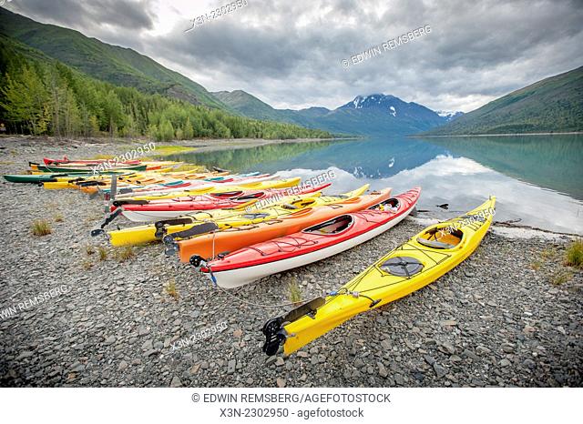 Kayaks in a row on shore at Lake Eklutna near Anchorage Alaska