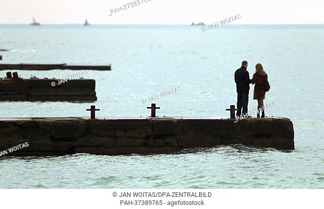 A couple stands on a jetty on the beach of Sochi, Russia, 5 February 2013. The 2014 Winter Olympics are going to take place in the Black Sea resort of Sochi