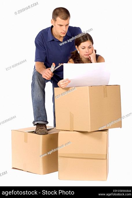 man and woman (workers) standing at the cardboard boxes