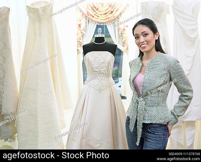Young woman standing in a bridal boutique