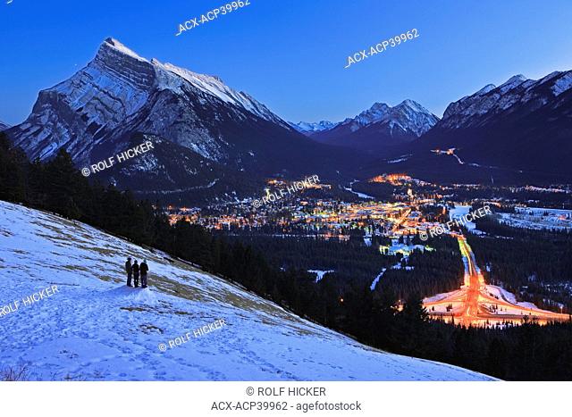 Aerial view at dusk of the town of Banff viewed from Norquay Meadow along Mount Norquay Road during winter after snow fall with Mt Rundle 2949 metres/9675 feet...