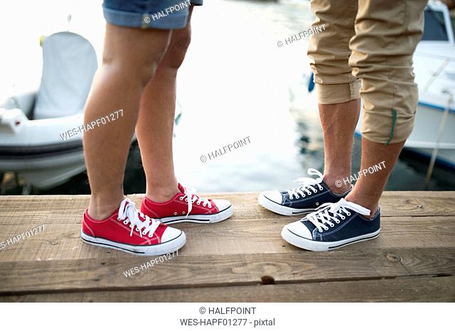 Senior couple wearing sneakers, partial view