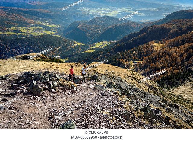 Italy, Trentino Alto Adige, Non valley, two women hikers climb to the summit of Luco Mount in autumn day