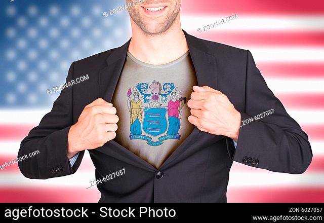 Businessman opening suit to reveal shirt with state flag (USA), New Jersey