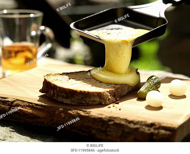 Raclette with bread, gherkins and pearl onions