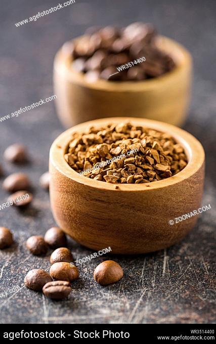 The instant coffee and coffee beans on old kitchen table
