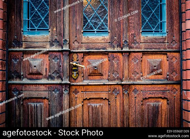 closeup of old wooden door with metal handle