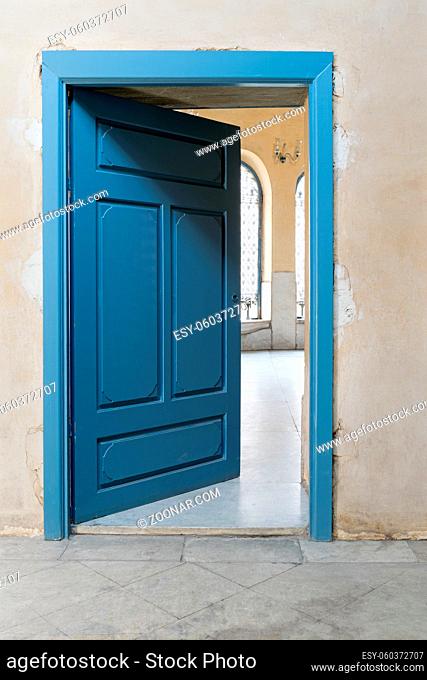 Blue wooden vintage door with yellow plaster wall, Cairo, Egypt