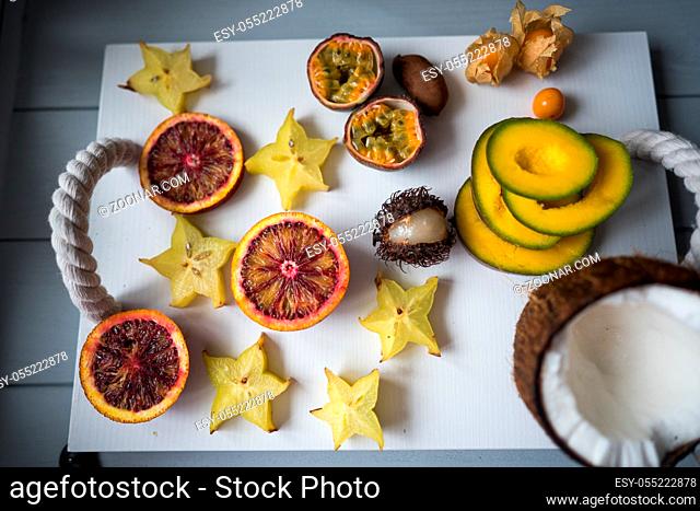 Exotic fruits on a tray on a light background