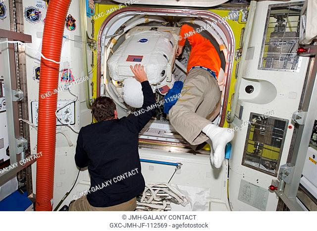 Attired in his Extravehicular Mobility Unit (EMU) spacesuit, NASA astronaut Alvin Drew, STS-133 mission specialist, enters the International Space Station's...