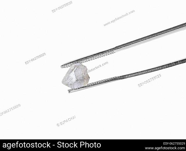 natural diamond on white background held in diamond tweezers