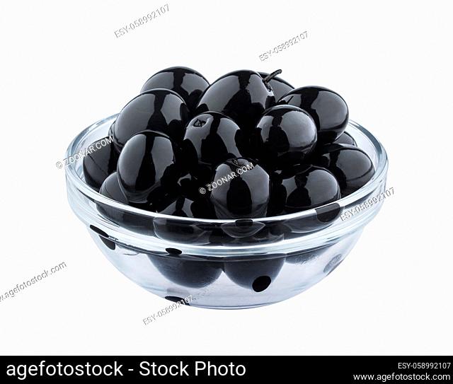 Heap of black olives in glass bowl isolated on white background with clipping path, close up