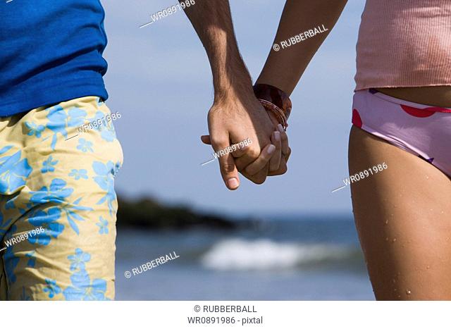 Close-up of a young couple holding hands
