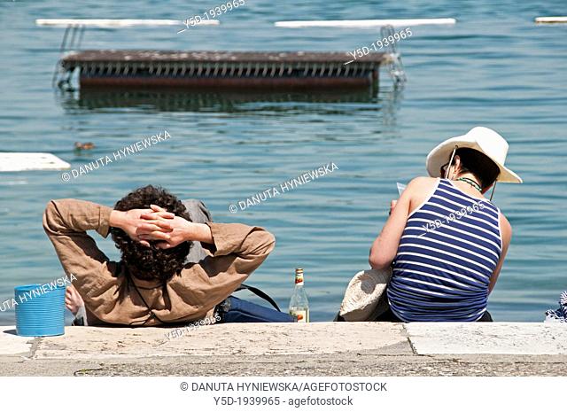 people resting at the shore of Geneva Lake, Paquis beach, Geneva, Switzerland, Europe